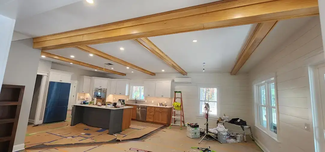 Modern kitchen with wooden beams and island.