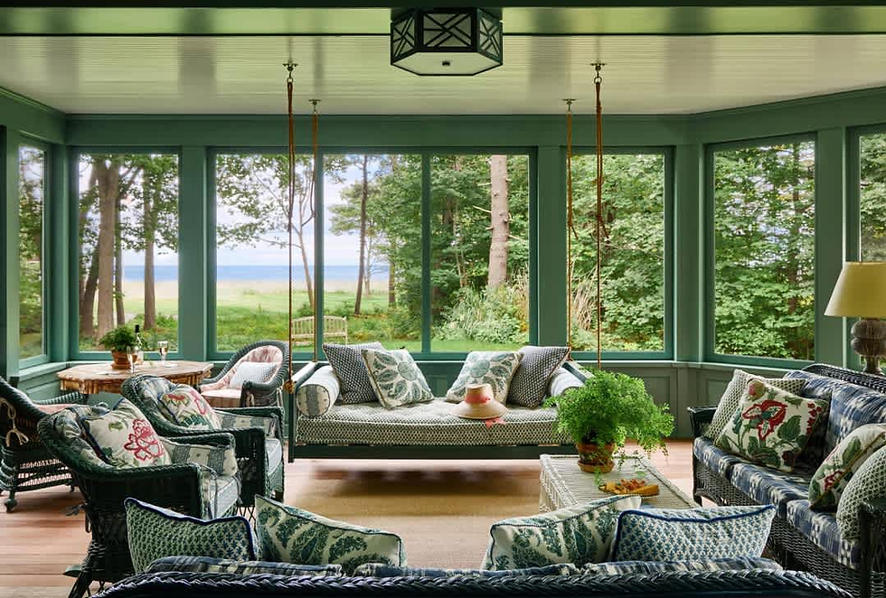 Screened porch with seating overlooking coastal Maine landscape