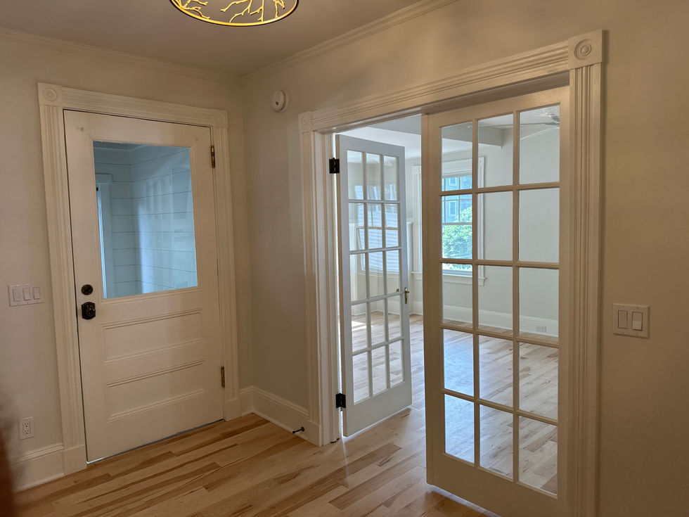 Room with wooden floor and glass-paneled doors.