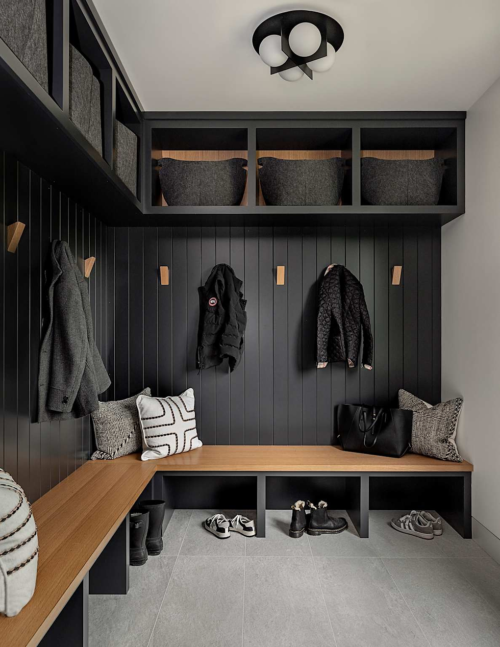 Custom mudroom with built-in bench, hooks, and boot storage