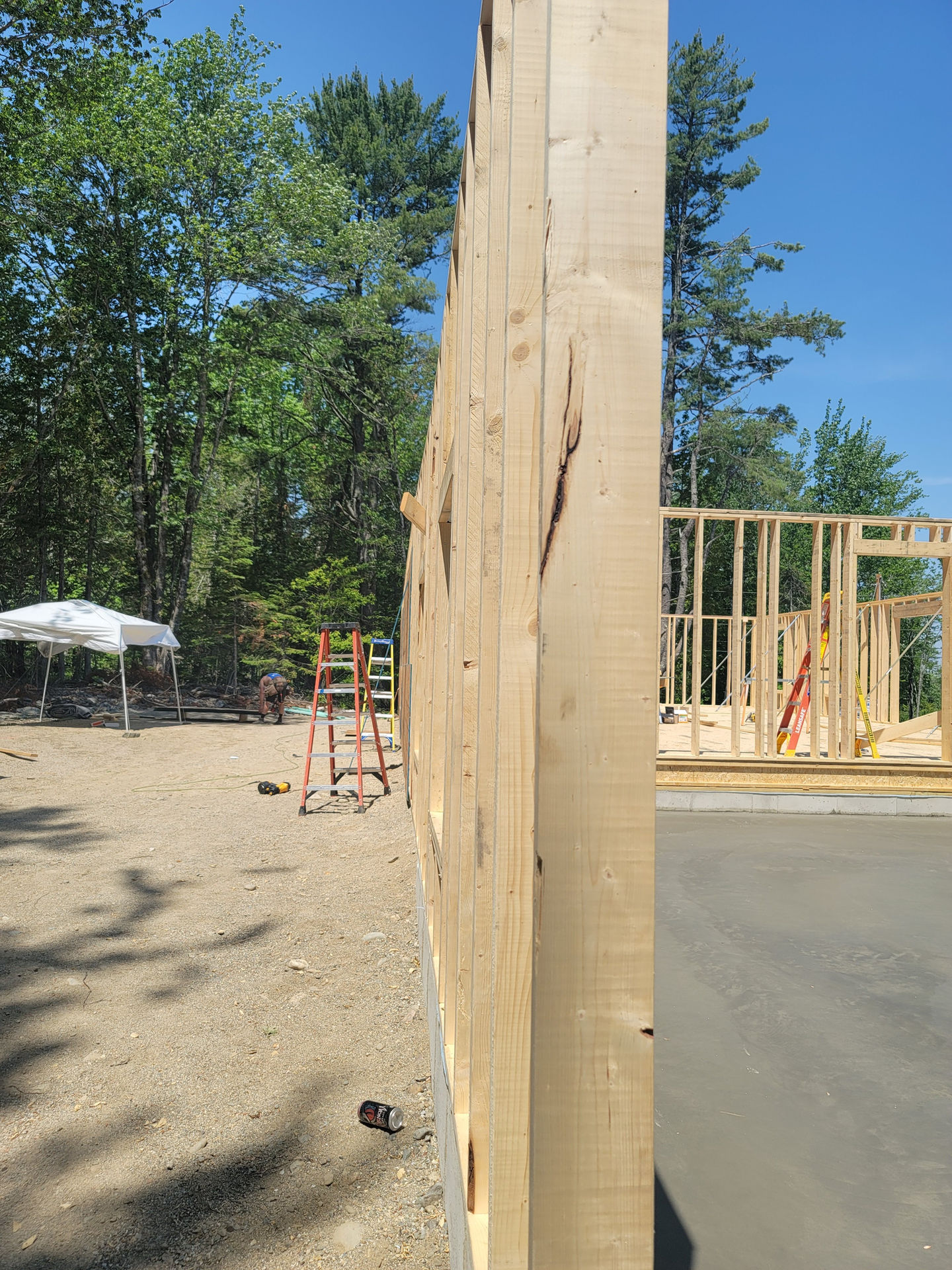 Wooden wall under construction in outdoor setting.