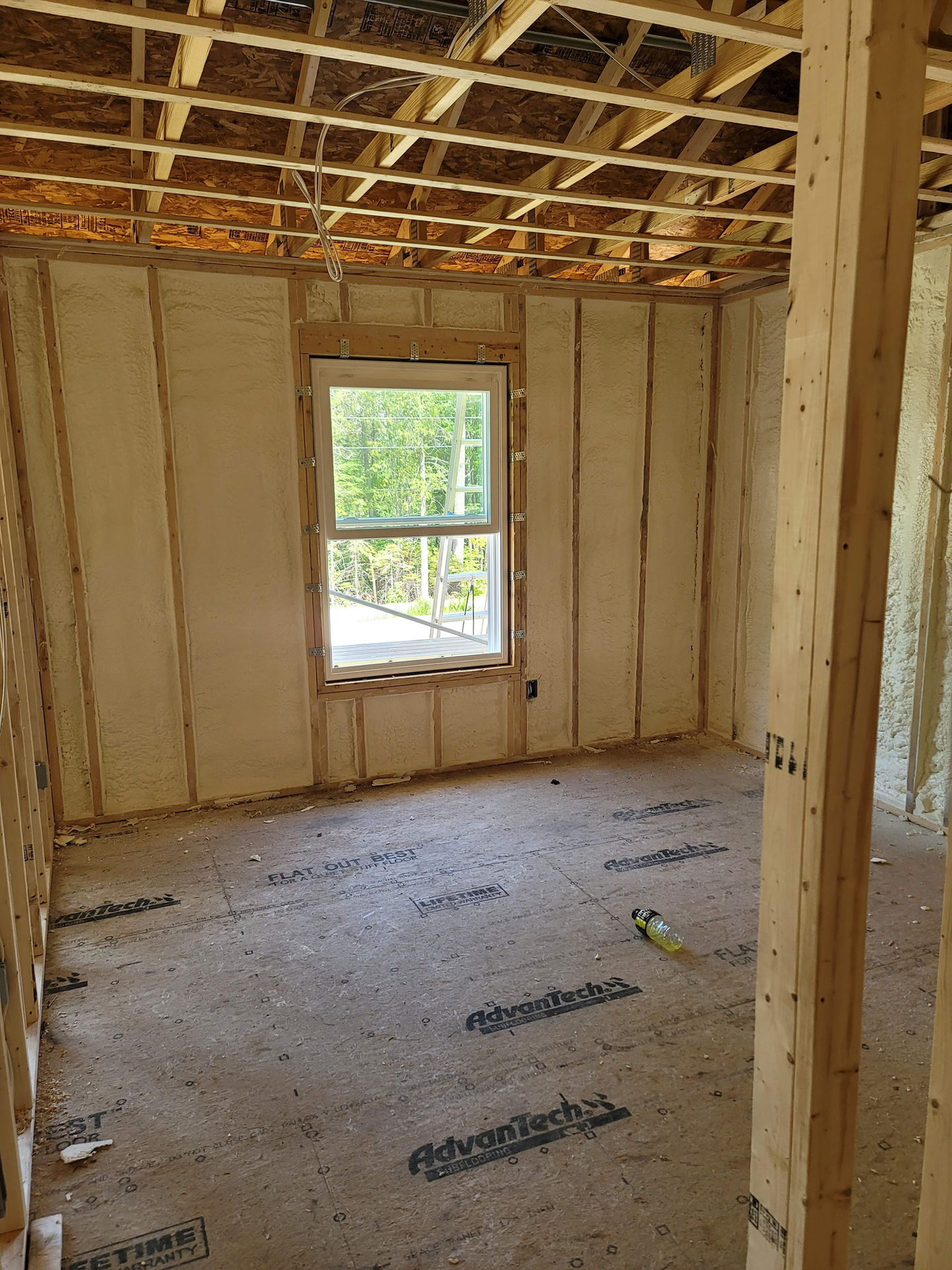 Room under construction with exposed wooden framework.