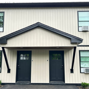 Building under construction with green sheathing.