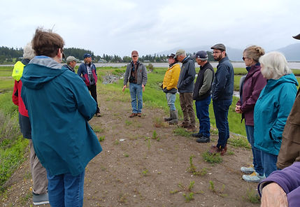 Charrette participants gathered in a circle on a dike at Samish Neck, June 2024