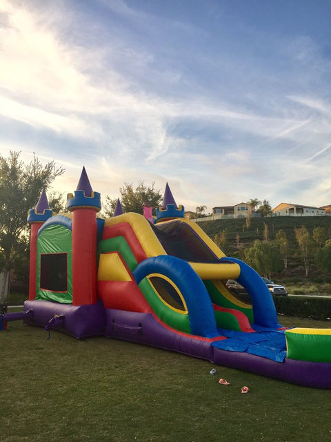 Another sparkling clean setup by Gold Star Jumpers of the 5 - 1 Castle Deluxe Dual Lane Bounce House Rental(Wet/Dry) on a beautiful summer day in Irvine, California.