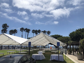 Summer costal event setup with tents, tables, and chair rentals from Gold Star Jumpers in Newport, California.