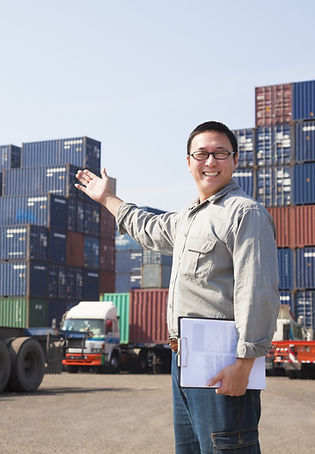 Smiling Person Standing In Front Of Container, Ocean Freight, Sea Freight, Air Cargo, Sea Cargo, Containers, Cargo, Shipping, Export, Import, Customs Clearances, Customs Brokerages, Goods, Perishables, Supply Chain, Solutions, Logistics, Supply Chain Optimisation, Land Transportation, Port, Trucking, Trailers, 40 feet containers, TEUs, 20 feet containers, Team, Operations Team, Innovative team, solving supply chain problems