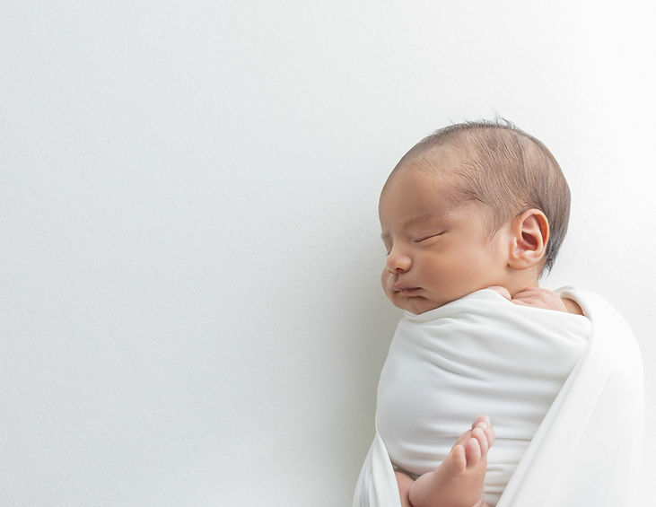 Newborn boy wrapped in white in San Diego Newborn Photography Studio