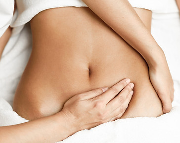 Hands-massaging-female-abdomen.Therapist-applying-pressure-on-belly.-854292120_3866x2580-s