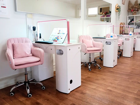 row of pink seats and white tables in the store