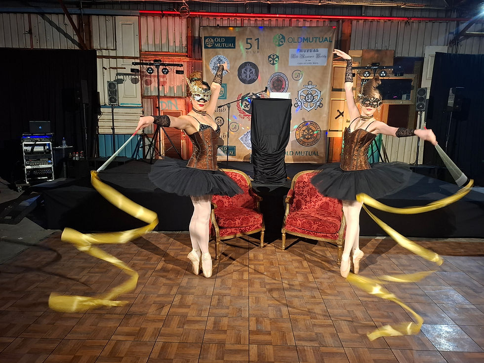 Eye-level view of a vintage-themed event setup with gold accents and jazz instruments