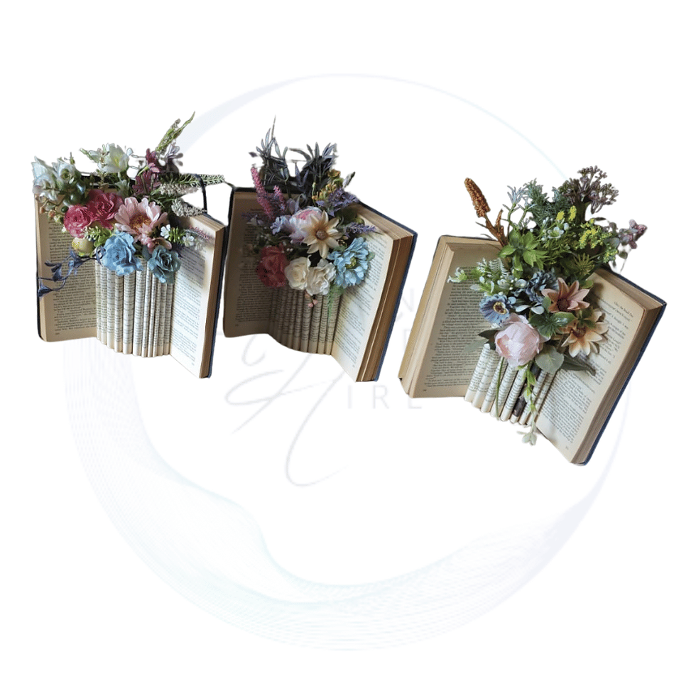 Flowers arranged in an old book centrepiece, perfect for vintage weddings, literary themed events, and elegant table décor.