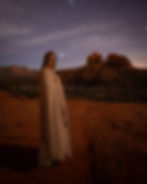 A model stands under the stars in front of Cathedral Rock in Sedona