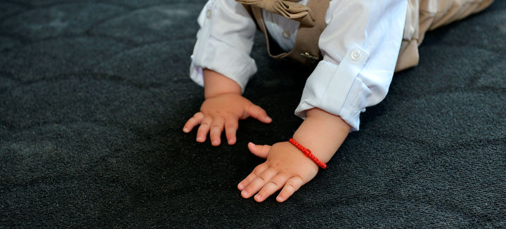 hands-baby-boy-while-crawling-black-carpet.jpg