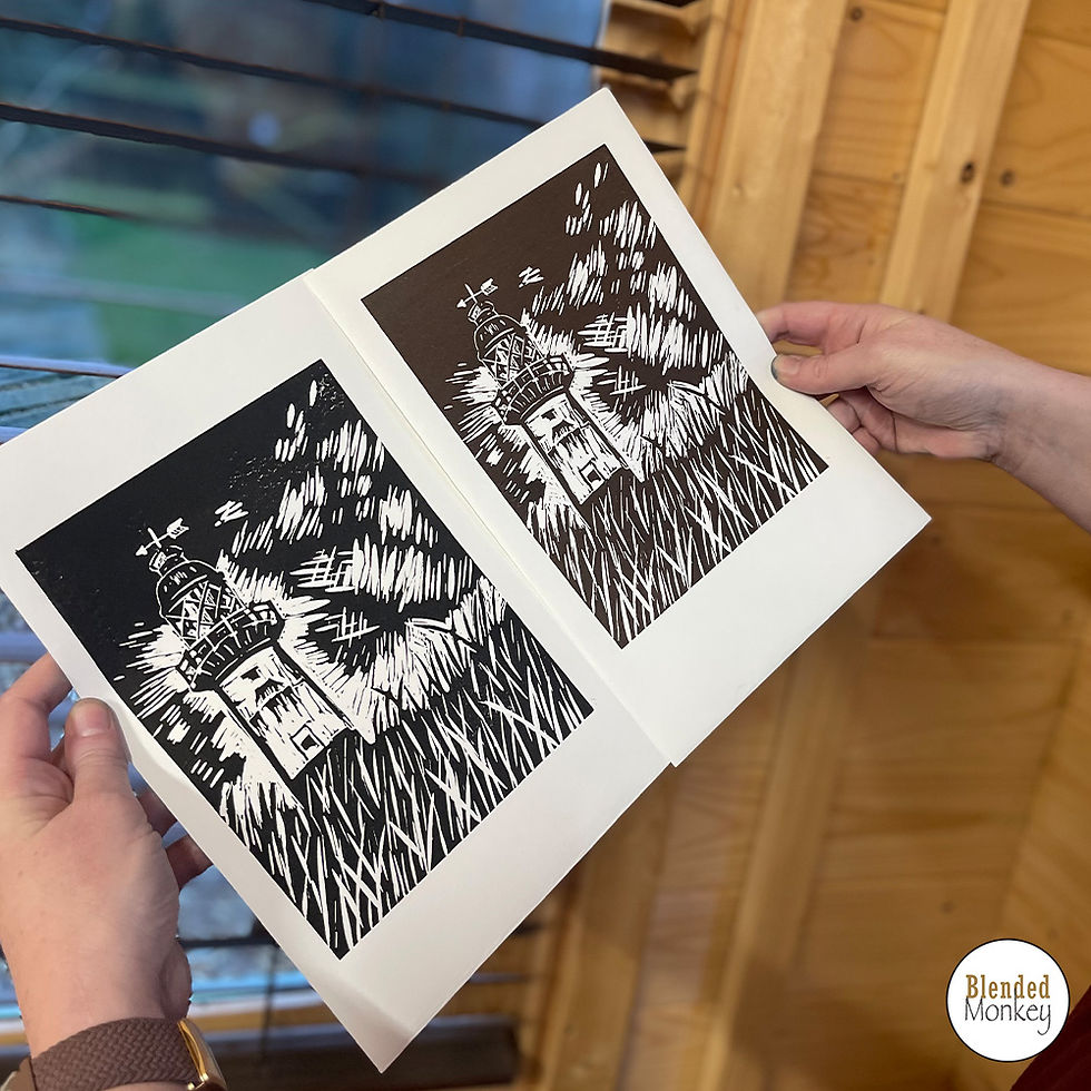 Student's black and brown print of their lighthouse design created in our linocut printing workshop here at Blended Monkey