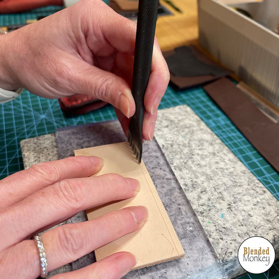 Punching holes in the leather
