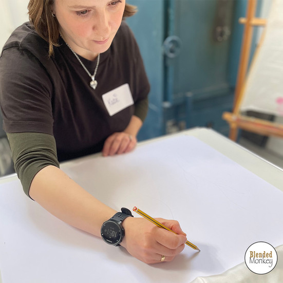 Students drawing out their designs on their scarves
