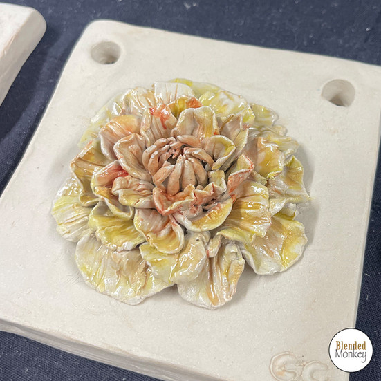 Clay blossom tiles created during a sculpture workshop at Blended Monkey