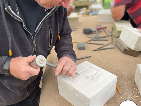 Student starting to carve the letter P in his Portland stone