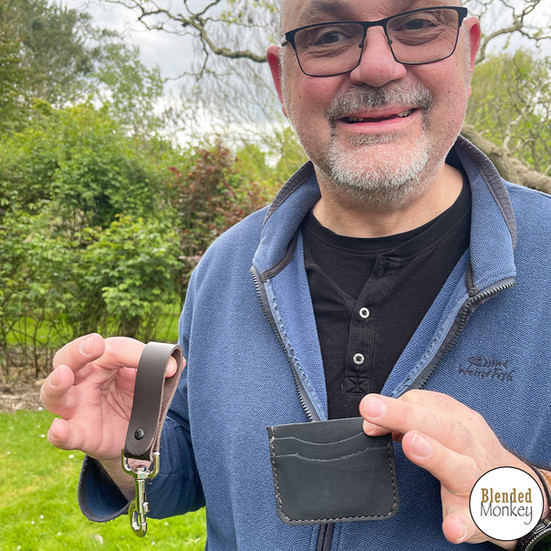 Happy student showing off his handmade leather card case and belt loop