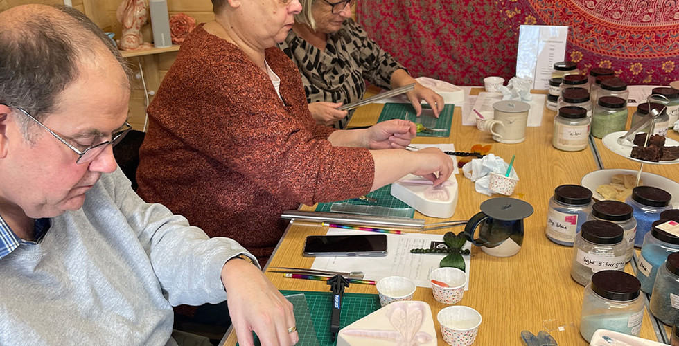 Students enjoying cutting the glass for their fused glass hanging pieces