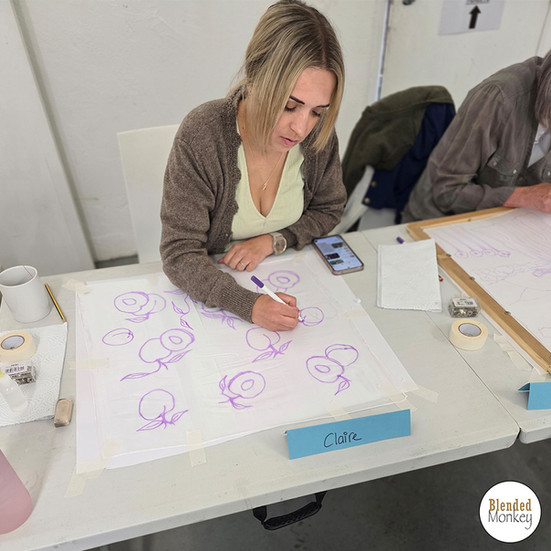 Student adding her design to her silk at our Blended Monkey silk painting workshop