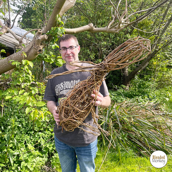 One our students posing with their beautiful willow hare sculpture in the Blended Monkey gardens