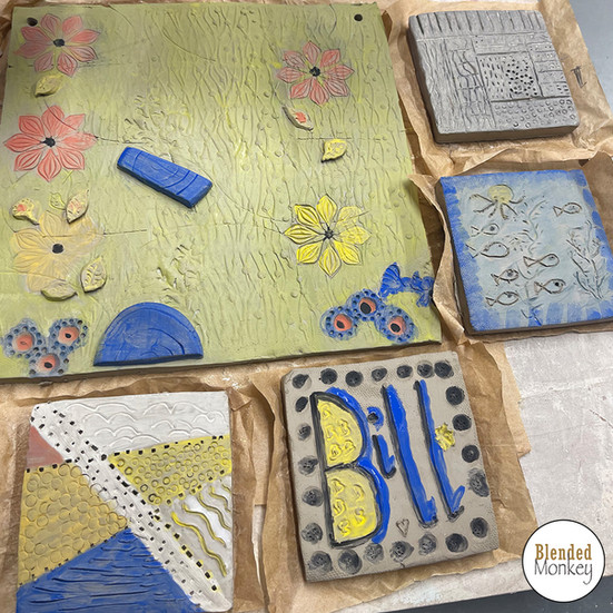 Student's tile and coaster glazed ready to be dried and fired