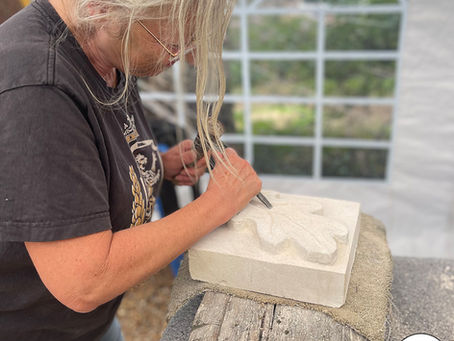 Student chiselling out a lovely relief oak leaf in the Blended Monkey Studios & Gardens