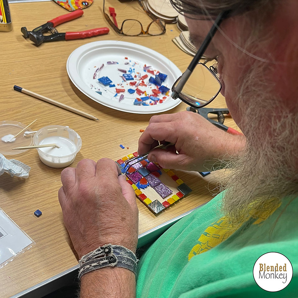 Neil placing the mosaic pieces on his tile