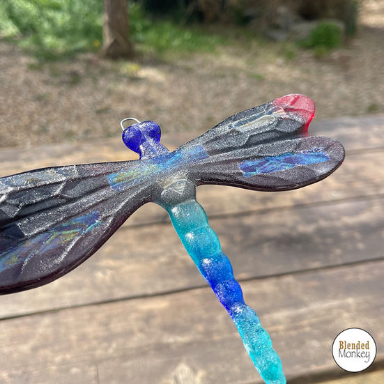 Beautiful multicoloured fused glass dragonfly made at our Blended Monkey fused glass workshop