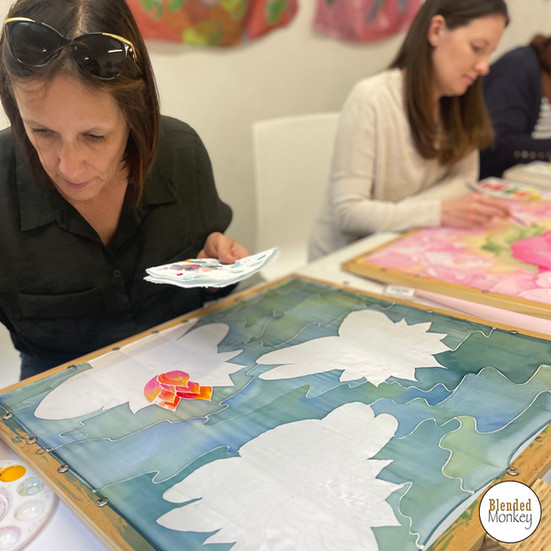 Student enjoying painting her silk