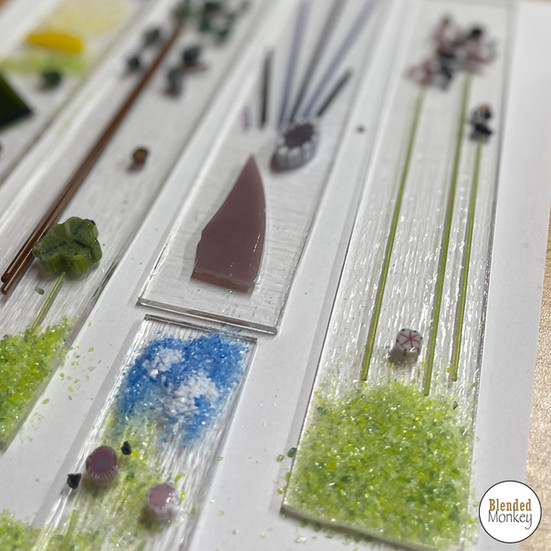 Trees and flowers depicted on these fused glass wind chimes