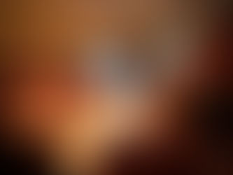 Five women in swimsuits relax and converse inside a wooden sauna. Warm lighting and steam create a calm, cozy atmosphere.