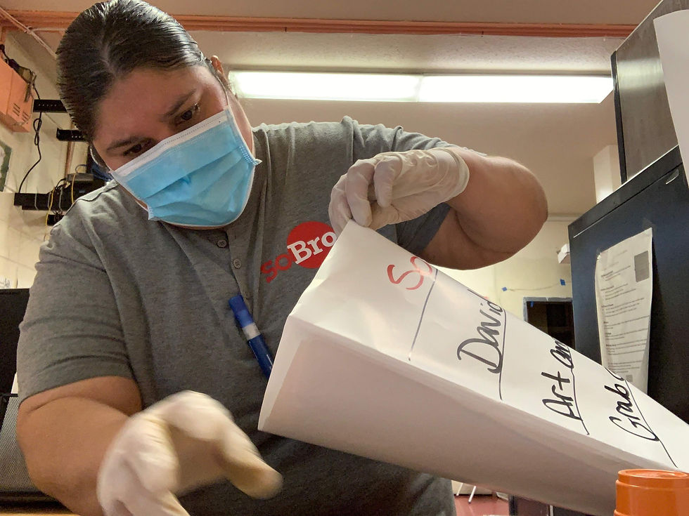 SoBro employee preparing craft kits for children