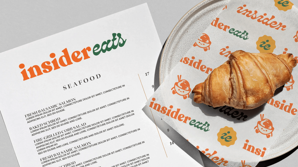 a menu for insider eats seafood with a croissant on a plate