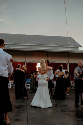 bride and groom dancing on the patio in the summer