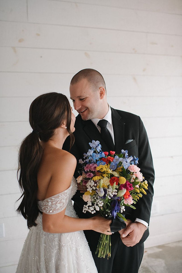 groom gazing at bride at white barn wedding venue in toledo ohio