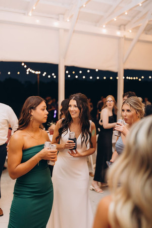 bride chit chatting during dancing at her outdoor wedding reception