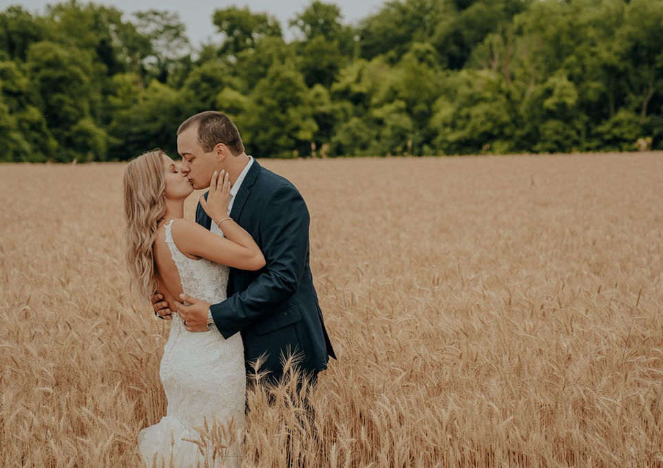 Bride and groom in a field