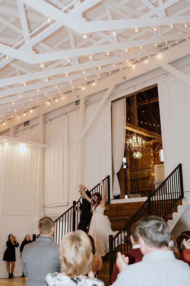 bride and groom walking into wedding reception