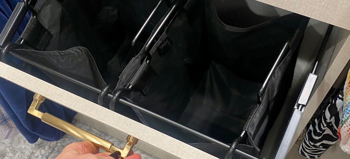 Very efficient black canvas laundry bags attached to tilt out door.