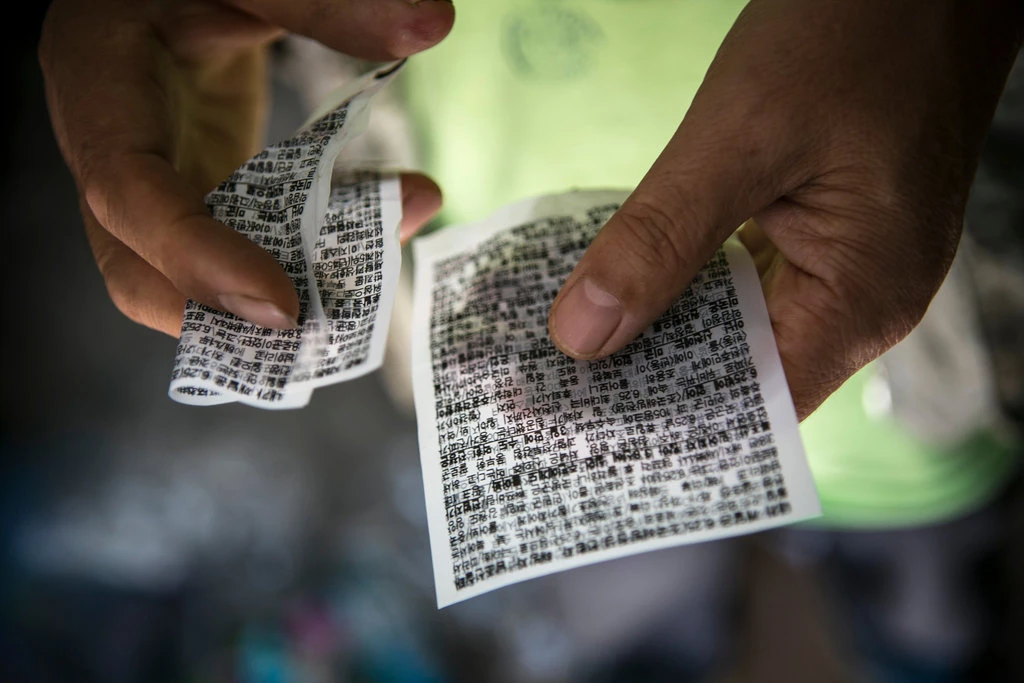 Two of Mr. Lee’s propaganda leaflets, printed on thin plastic. Credit. Jean Chung for The New York Times