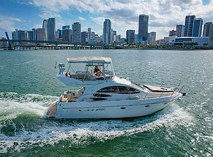 A luxurious 55 Azimut yacht floating serenely on crystal-clear waters, showcasing its sleek design, expansive sun deck, and e