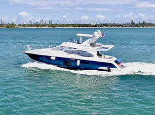 A luxurious 55 Azimut yacht floating serenely on crystal-clear waters, showcasing its sleek design, expansive sun deck, and e
