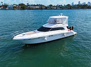 A luxurious 55 Azimut yacht floating serenely on crystal-clear waters, showcasing its sleek design, expansive sun deck, and e