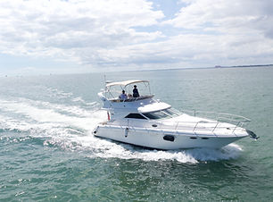 A luxurious 55 Azimut yacht floating serenely on crystal-clear waters, showcasing its sleek design, expansive sun deck, and e