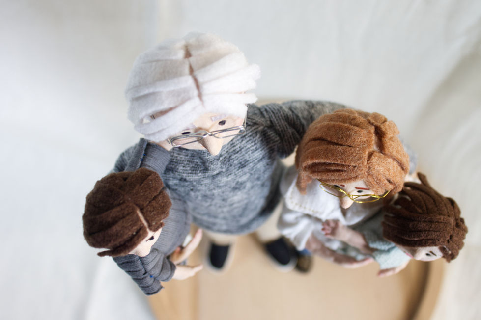 Close-up of textile and wooden puppets representing grandparents and grandchildren
Detail of puppets hair