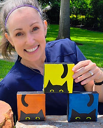 Artist Celeste Seitz holding art samples