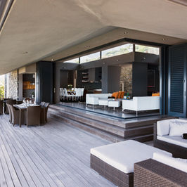 Outdoor patio with seating, open door to living room, INTERIOR REMODELING, sunny day.